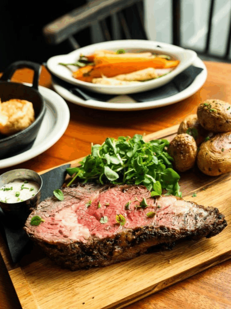 Sunday Roast is the one worth planning your week around. Roasted meat, Yorkshire pudding, roast potatoes, seasonal vegetables, beef gravy, and horseradish sauce, a tradition that traces back to the reign of King Henry VII.